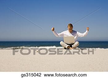 Stock Photo - man at beach on 
laptop. fotosearch 
- search stock 
photos, pictures, 
images, and photo 
clipart