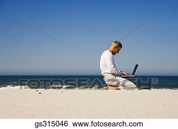 Stock Photo - man kneeling on 
beach with laptop. 
fotosearch - search 
stock photos, 
pictures, images, 
and photo clipart