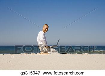 Picture - man kneeling on 
beach with laptop. 
fotosearch - search 
stock photos, 
pictures, images, 
and photo clipart