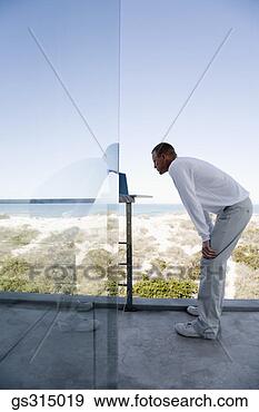 Stock Photograph - man with laptop 
on balcony. fotosearch 
- search stock 
photos, pictures, 
images, and photo 
clipart