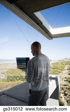 Stock Photo - man with laptop 
through window. 
fotosearch - search 
stock photos, 
pictures, images, 
and photo clipart