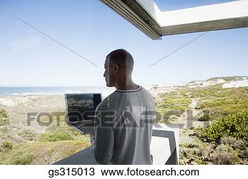 Stock Photo - man with laptop 
through window. 
fotosearch - search 
stock photos, 
pictures, images, 
and photo clipart