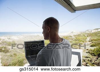 Stock Photo - man with laptop. 
fotosearch - search 
stock photos, 
pictures, images, 
and photo clipart