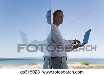 Stock Photo - man with laptop. 
fotosearch - search 
stock photos, 
pictures, images, 
and photo clipart
