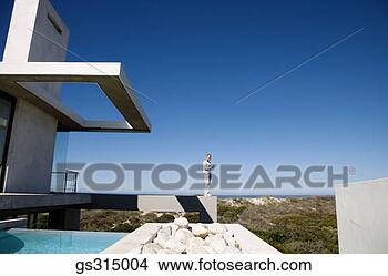 Stock Photo - man on ledge by 
pool. fotosearch 
- search stock 
photos, pictures, 
images, and photo 
clipart