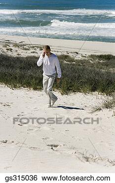 Stock Photo - man on phone at 
beach. fotosearch 
- search stock 
photos, pictures, 
images, and photo 
clipart