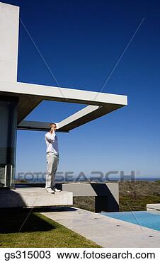 Stock Photo - man on phone by 
pool. fotosearch 
- search stock 
photos, pictures, 
images, and photo 
clipart