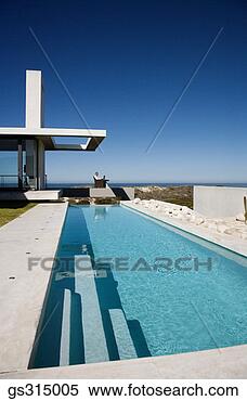 Stock Image - man sitting by 
pool. fotosearch 
- search stock 
photos, pictures, 
images, and photo 
clipart