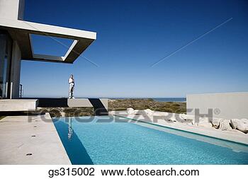 Stock Photo - man standing on 
ledge by pool. 
fotosearch - search 
stock photos, 
pictures, images, 
and photo clipart