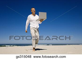 Stock Photo - man walking on 
beach with laptop. 
fotosearch - search 
stock photos, 
pictures, images, 
and photo clipart