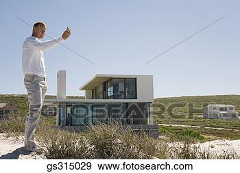 Stock Photograph - mat at beach with 
camera phone. 
fotosearch - search 
stock photos, 
pictures, images, 
and photo clipart
