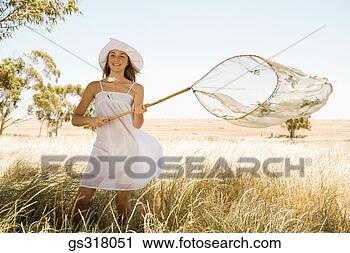Stock Photography - woman catching 
butterflies in 
net. fotosearch 
- search stock 
photos, pictures, 
images, and photo 
clipart