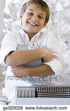 Stock Photo - boy holding christmas 
gift. fotosearch 
- search stock 
photos, pictures, 
images, and photo 
clipart