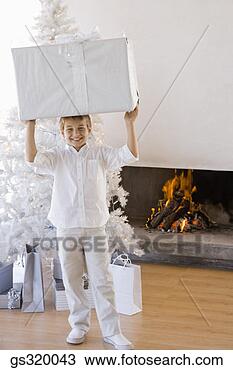 Stock Photo - boy holding large 
christmas gift. 
fotosearch - search 
stock photos, 
pictures, images, 
and photo clipart