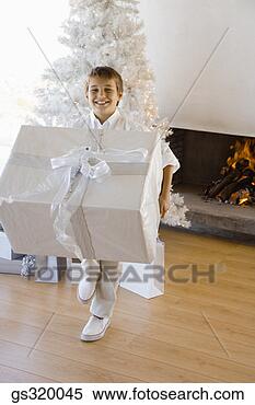 Stock Image - boy holding large 
christmas gift. 
fotosearch - search 
stock photos, 
pictures, images, 
and photo clipart