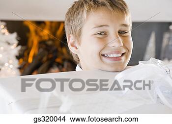 Stock Photo - boy smiling with 
christmas gift. 
fotosearch - search 
stock photos, 
pictures, images, 
and photo clipart