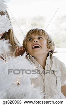 Stock Photo - boy smiling at 
christmas tree. 
fotosearch - search 
stock photos, 
pictures, images, 
and photo clipart