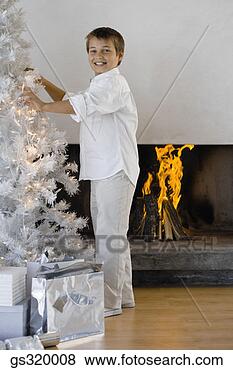 Stock Photo - boy standing by 
modern christmas 
tree. fotosearch 
- search stock 
photos, pictures, 
images, and photo 
clipart