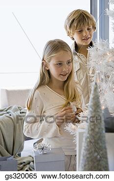 Stock Image - children decorating 
christmas tree. 
fotosearch - search 
stock photos, 
pictures, images, 
and photo clipart