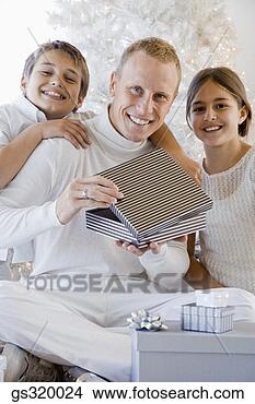 Stock Photo - children with 
father opening 
christmas gift. 
fotosearch - search 
stock photos, 
pictures, images, 
and photo clipart