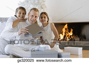 Stock Image - children with 
father opening 
christmas gift. 
fotosearch - search 
stock photos, 
pictures, images, 
and photo clipart
