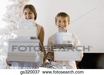 Picture - children holding 
christmas gifts. 
fotosearch - search 
stock photos, 
pictures, images, 
and photo clipart