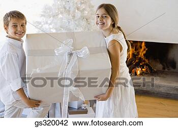 Stock Photo - children holding 
large christmas 
gift. fotosearch 
- search stock 
photos, pictures, 
images, and photo 
clipart