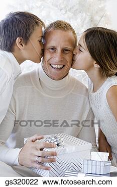 Stock Photo - children kissing 
father with gift. 
fotosearch - search 
stock photos, 
pictures, images, 
and photo clipart