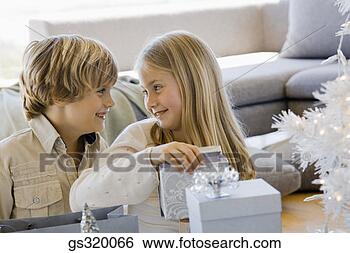 Stock Photo - children opening 
christmas gifts. 
fotosearch - search 
stock photos, 
pictures, images, 
and photo clipart