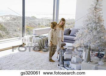 Stock Photography - children standing 
by contemporary 
christmas tree. 
fotosearch - search 
stock photos, 
pictures, images, 
and photo clipart