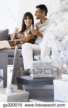 Stock Image - couple drinking 
wine by christmas 
tree. fotosearch 
- search stock 
photos, pictures, 
images, and photo 
clipart