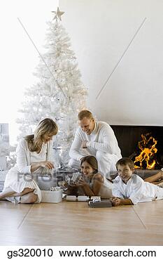 Stock Photography - family by christmas 
tree. fotosearch 
- search stock 
photos, pictures, 
images, and photo 
clipart