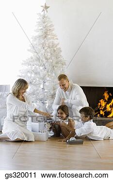 Stock Photography - family by christmas 
tree. fotosearch 
- search stock 
photos, pictures, 
images, and photo 
clipart