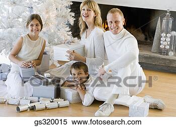 Stock Image - family by christmas 
tree. fotosearch 
- search stock 
photos, pictures, 
images, and photo 
clipart
