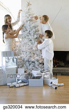 Stock Photo - family decorating 
christmas tree. 
fotosearch - search 
stock photos, 
pictures, images, 
and photo clipart