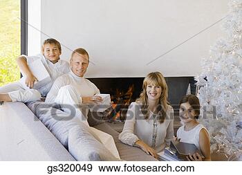 Stock Photograph - family lounging 
with christmas 
gifts. fotosearch 
- search stock 
photos, pictures, 
images, and photo 
clipart