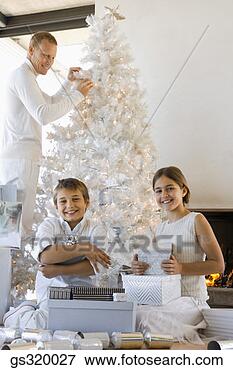 Picture - father and children 
by christmas tree. 
fotosearch - search 
stock photos, 
pictures, images, 
and photo clipart