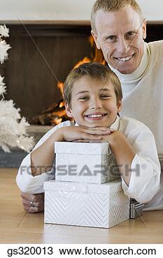 Stock Photo - father and son 
smiling with christmas 
gifts. fotosearch 
- search stock 
photos, pictures, 
images, and photo 
clipart