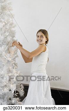 Stock Photography - girl decorating 
christmas tree. 
fotosearch - search 
stock photos, 
pictures, images, 
and photo clipart