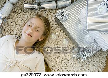 Stock Photo - girl lying on 
floor by gifts. 
fotosearch - search 
stock photos, 
pictures, images, 
and photo clipart