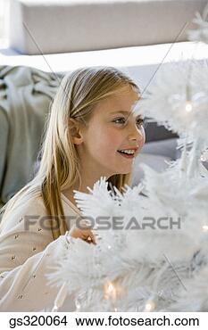 Stock Photo - girl smiling at 
christmas tree. 
fotosearch - search 
stock photos, 
pictures, images, 
and photo clipart