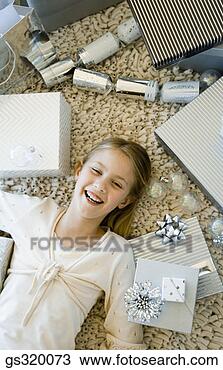 Stock Photo - girl smiling on 
floor by gifts. 
fotosearch - search 
stock photos, 
pictures, images, 
and photo clipart