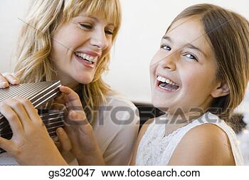 Picture - mother and daughter 
opening gift. 
fotosearch - search 
stock photos, 
pictures, images, 
and photo clipart