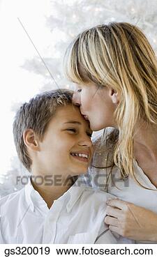 Stock Photograph - mother kissing 
smiling son. fotosearch 
- search stock 
photos, pictures, 
images, and photo 
clipart