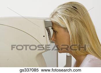 Stock Image - woman looking 
into auto no-contact 
tonometer. fotosearch 
- search stock 
photos, pictures, 
images, and photo 
clipart