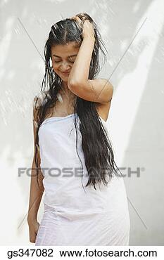 Stock Photo - woman standing 
in rain with wet 
hair. fotosearch 
- search stock 
photos, pictures, 
images, and photo 
clipart