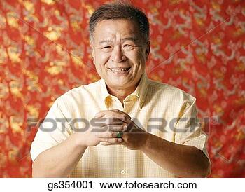 Stock Photography - man with chinese 
new year good 
luck hand gesture. 
fotosearch - search 
stock photos, 
pictures, images, 
and photo clipart