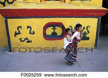 Stock Photograph - guatemala,  san 
andrés xecul, 
 young girls passing 
in front of the. 
fotosearch - search 
stock photos, 
pictures, images, 
and photo clipart