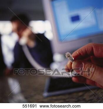 Stock Photography - man using disconnected 
phone. fotosearch 
- search stock 
photos, pictures, 
images, and photo 
clipart