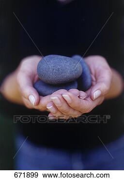 Stock Photograph - hands cupping 
stones. fotosearch 
- search stock 
photos, pictures, 
images, and photo 
clipart